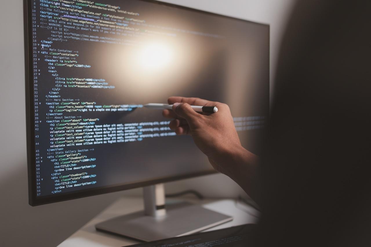 Developer reviewing tangled legacy code on a monitor